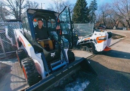 A professional hops out of a completely assembled skid steer loader.